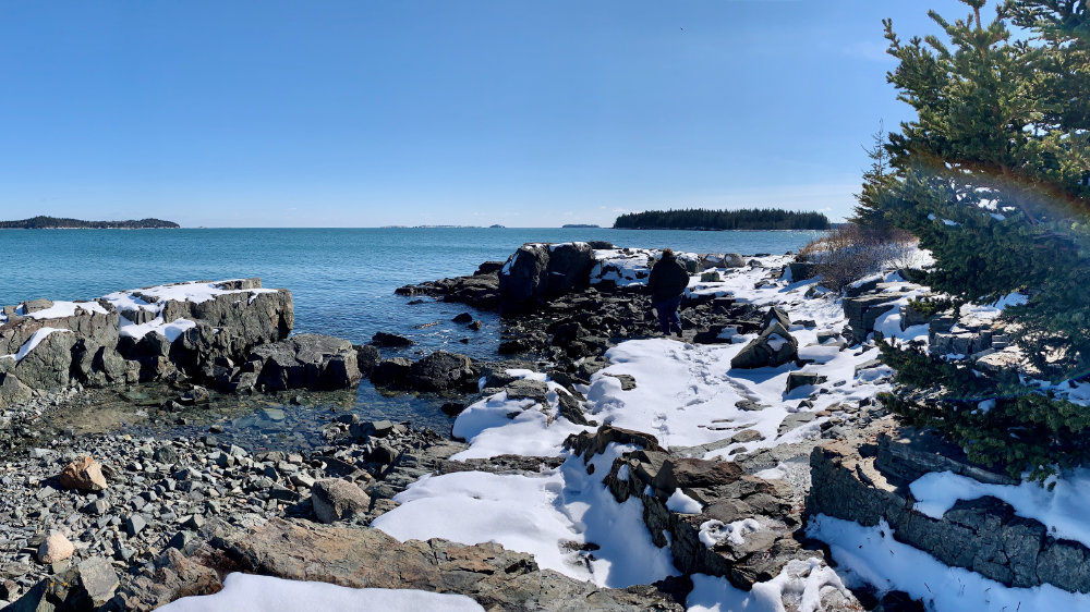 snow on the beach rocks in maine