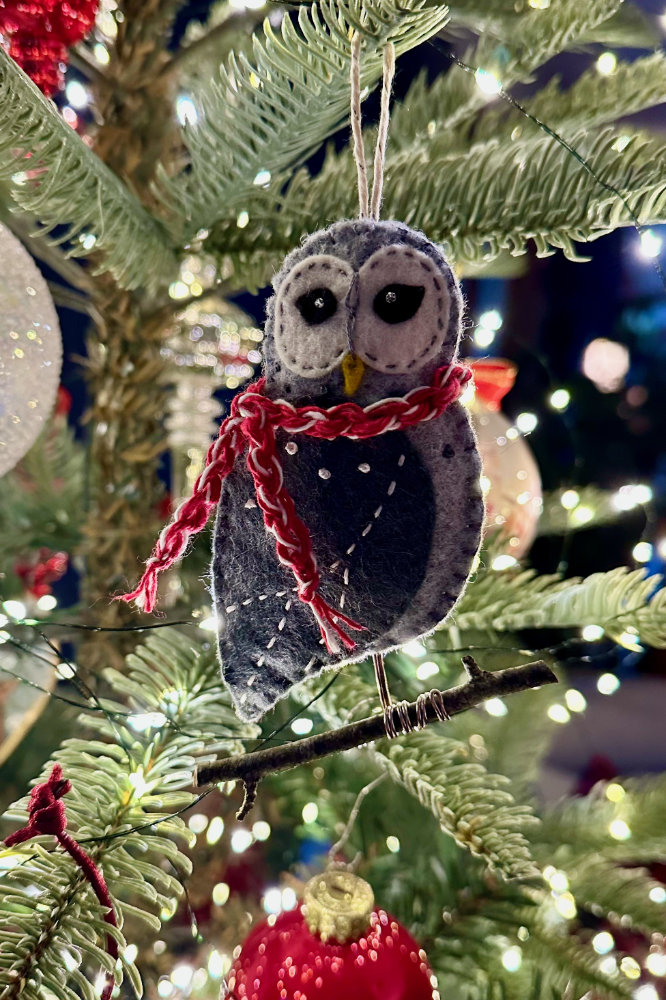 felt joyful owl ornament with a scarf perched on a twig